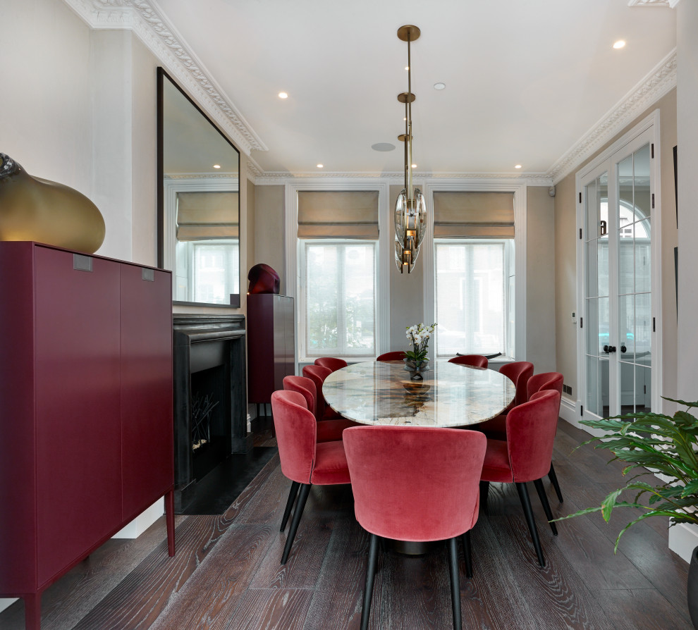 Large contemporary separate dining room in London with beige walls, a standard fireplace, medium hardwood floors, a metal fireplace surround and brown floor.