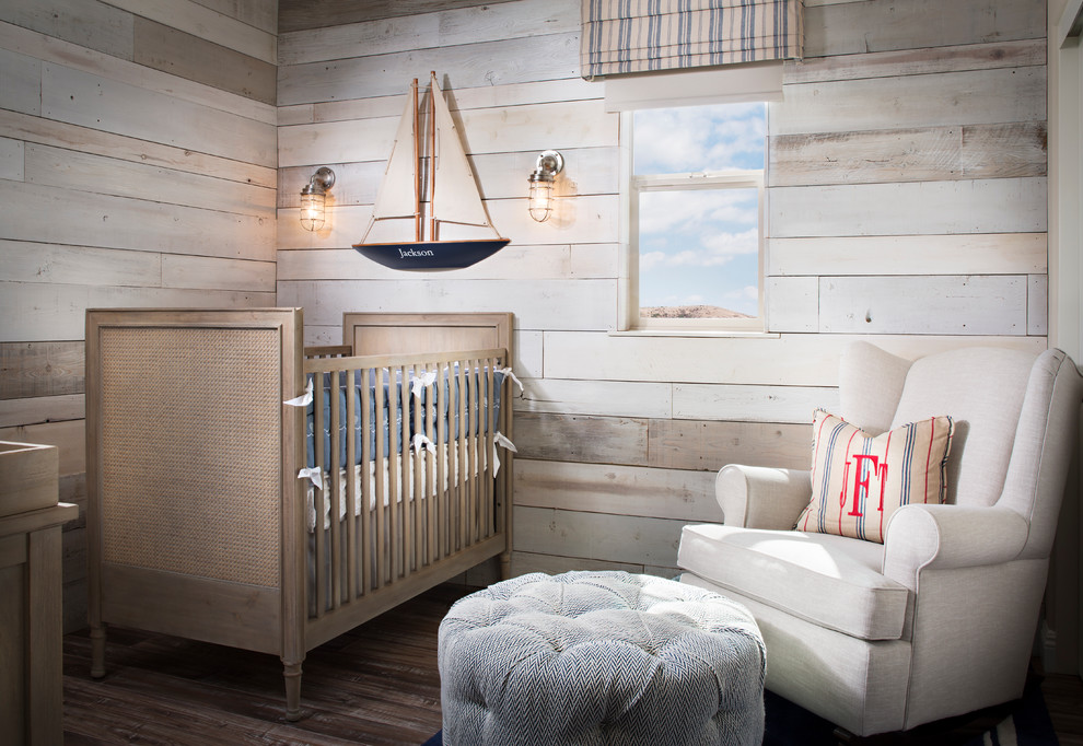 This is an example of a small beach style gender-neutral nursery in San Diego with beige walls and medium hardwood floors.