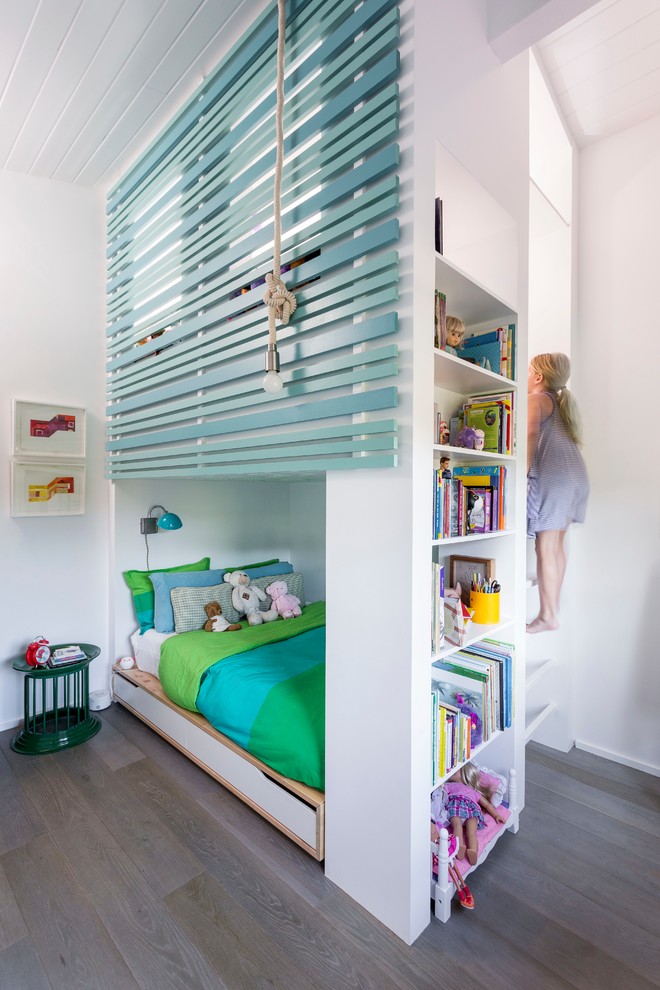 Inspiration for a contemporary kids' bedroom for girls in Los Angeles with white walls, medium hardwood floors and grey floor.