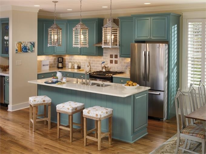 This is an example of a small traditional l-shaped eat-in kitchen in New York with an undermount sink, raised-panel cabinets, blue cabinets, quartzite benchtops, beige splashback, subway tile splashback, stainless steel appliances, medium hardwood floors and with island.