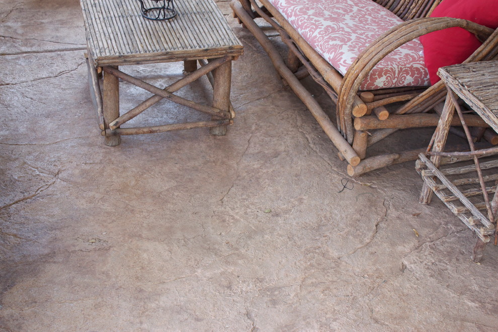 Example of a large trendy backyard stamped concrete patio design in Denver with no cover