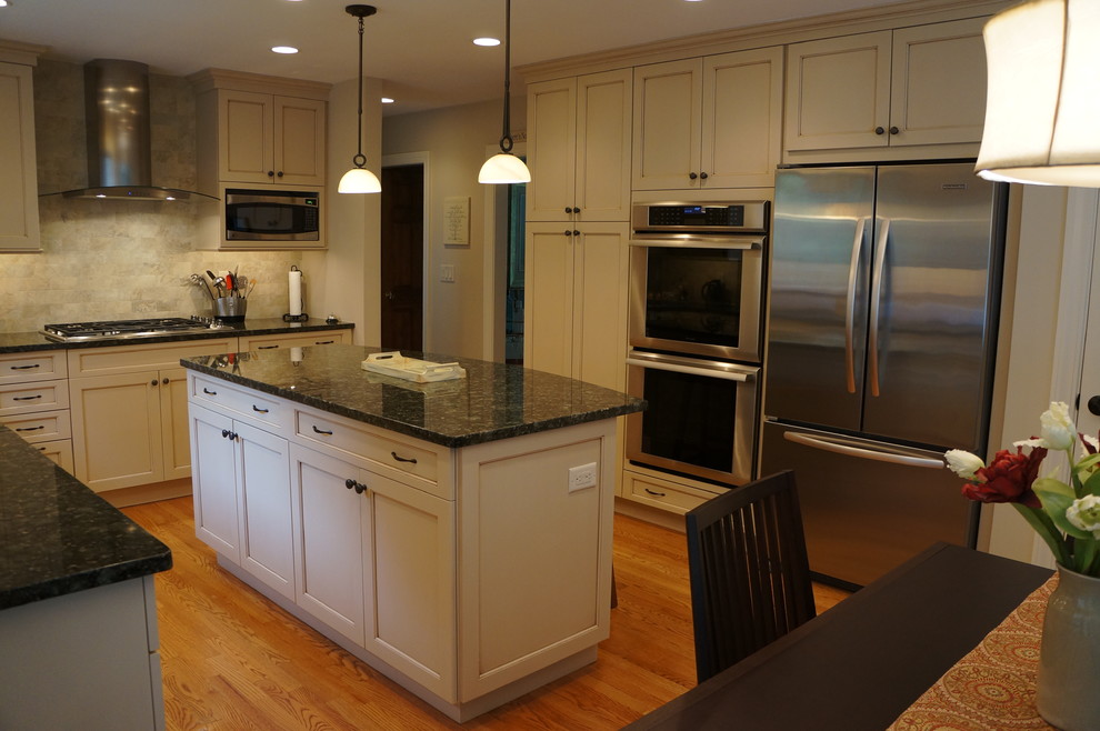 Transitional eat-in kitchen photo in Boston with an undermount sink, recessed-panel cabinets, white cabinets, granite countertops and an island