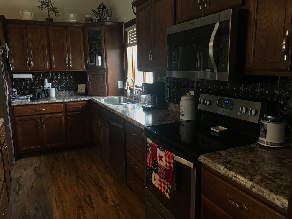 Kitchen - brown floor kitchen idea with brown cabinets, brown backsplash, an island and brown countertops