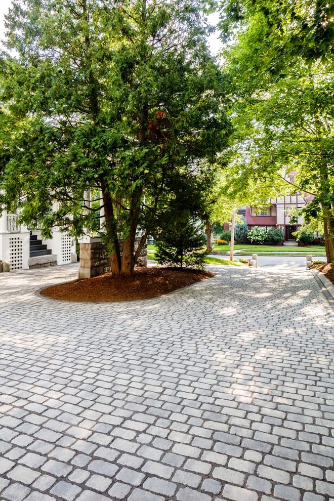 This is an example of a mid-sized traditional front yard garden in Manchester with concrete pavers.