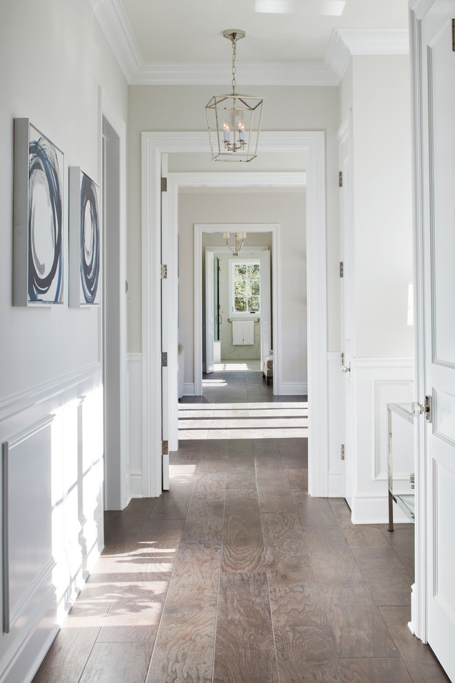 Photo of an expansive transitional hallway in Los Angeles with grey walls, dark hardwood floors and brown floor.