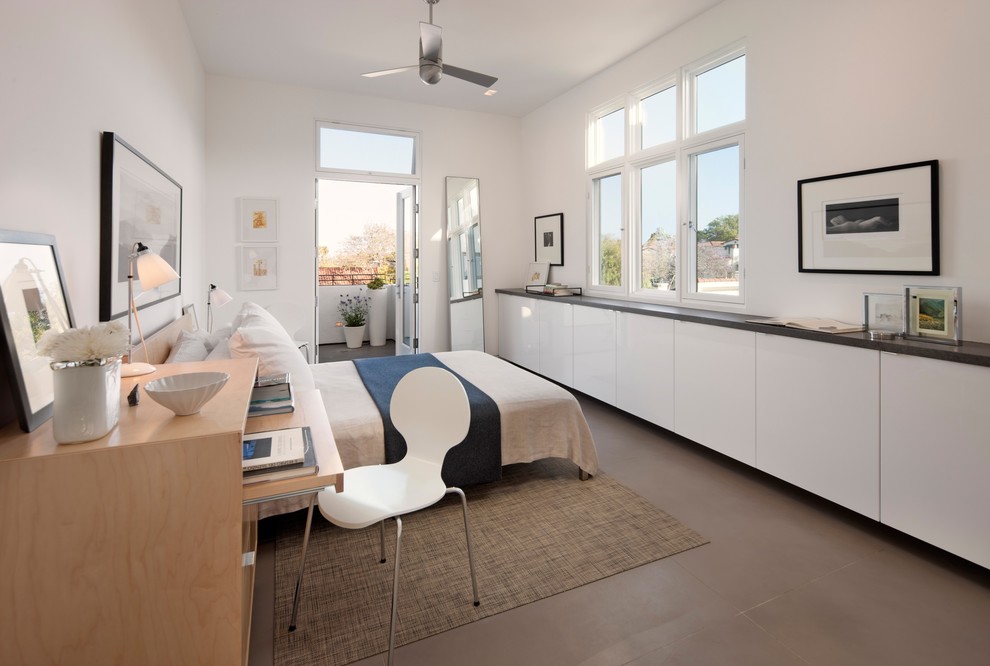 Contemporary master bedroom in Santa Barbara with white walls and concrete floors.