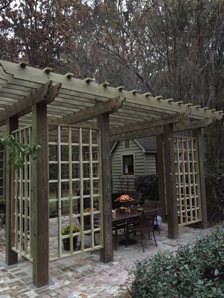 Example of a mid-sized transitional backyard concrete patio design in Jackson with a pergola