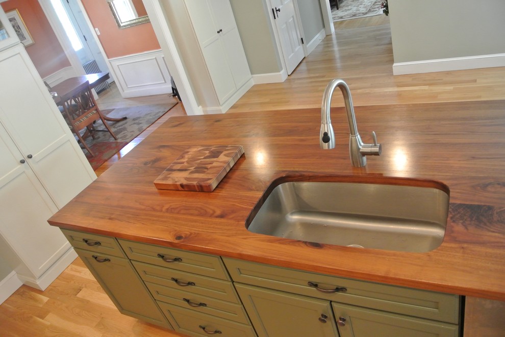 Transitional galley light wood floor eat-in kitchen photo in Boston with an undermount sink, shaker cabinets, white cabinets, wood countertops, white backsplash, ceramic backsplash, stainless steel appliances, an island and brown countertops