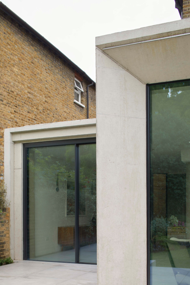 Contemporary three-storey concrete duplex exterior in London.