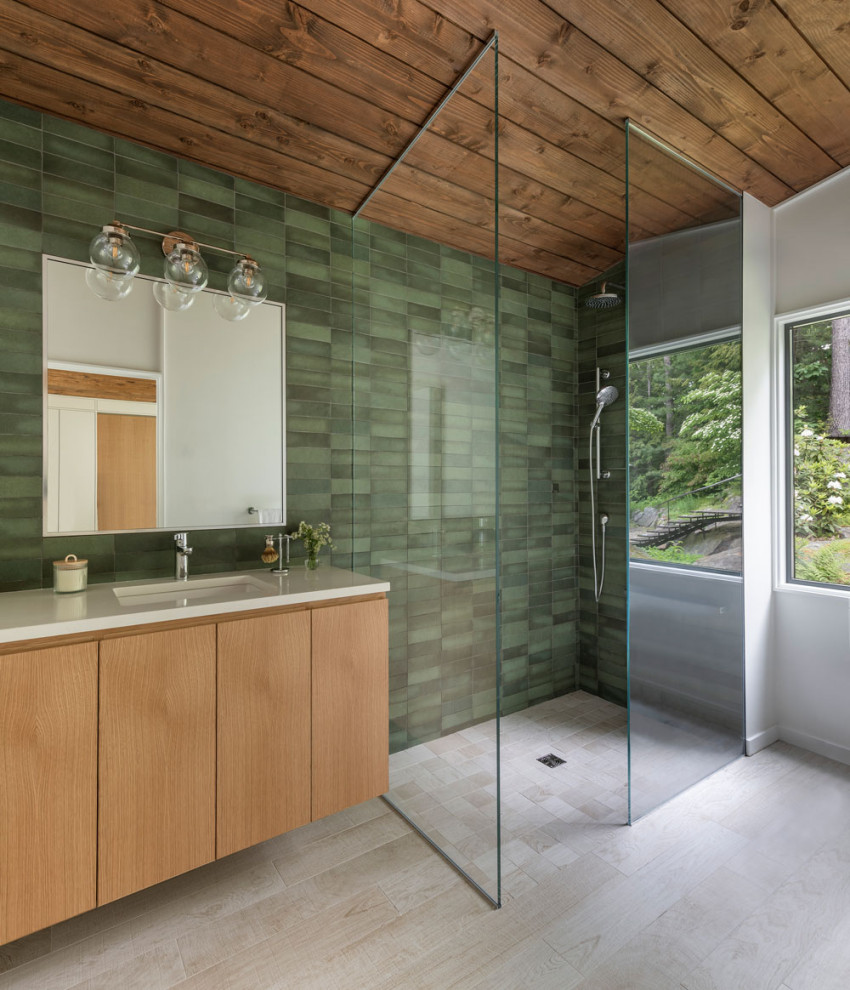 This is an example of a bathroom in Boston with green walls, light hardwood floors and beige floor.