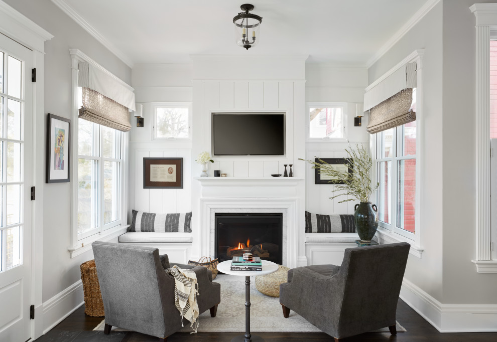 Inspiration for a transitional open concept family room in Chicago with grey walls, dark hardwood floors, a standard fireplace, a wall-mounted tv, brown floor and panelled walls.