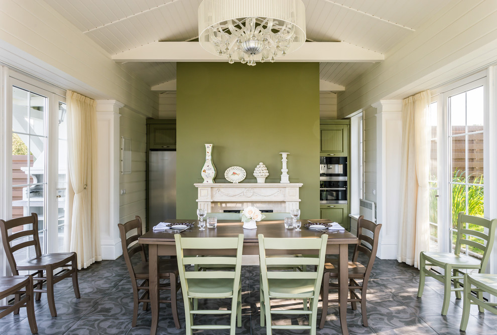Mid-sized traditional dining room in Moscow with green walls, ceramic floors, a standard fireplace and multi-coloured floor.