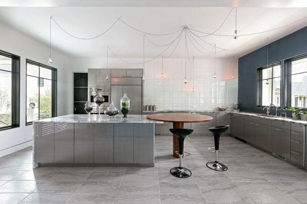Inspiration for a contemporary l-shaped eat-in kitchen in Charleston with an undermount sink, flat-panel cabinets, grey cabinets, panelled appliances and with island.