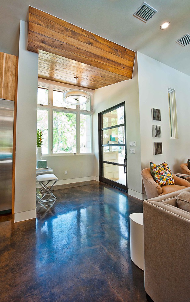 Inspiration for a contemporary entryway in Austin with concrete floors, a glass front door and brown floor.