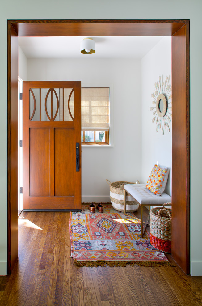 Transitional entryway in Los Angeles with white walls, dark hardwood floors, a single front door and a medium wood front door.