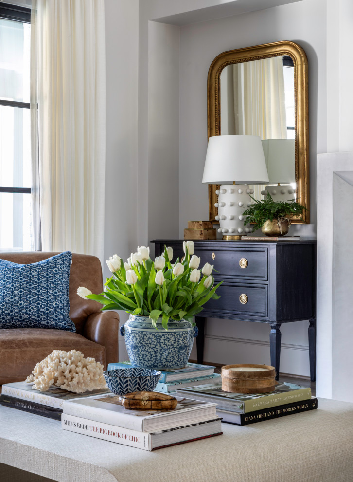 Inspiration for a large transitional open concept medium tone wood floor and brown floor family room remodel in Houston with beige walls, a plaster fireplace and a concealed tv