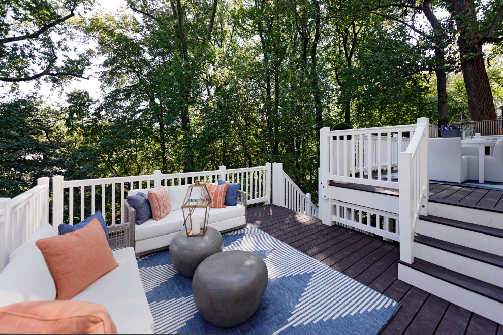 Photo of a beach style deck in DC Metro with wood railing.