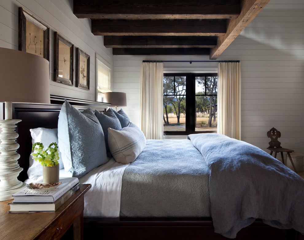 Country master bedroom in Austin with white walls.