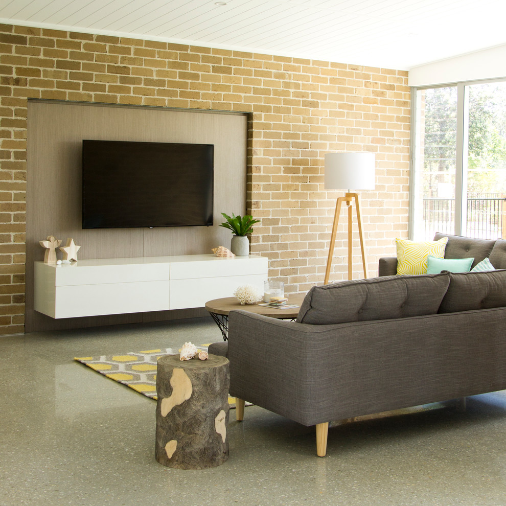 This is an example of a modern open concept living room in Gold Coast - Tweed with concrete floors.