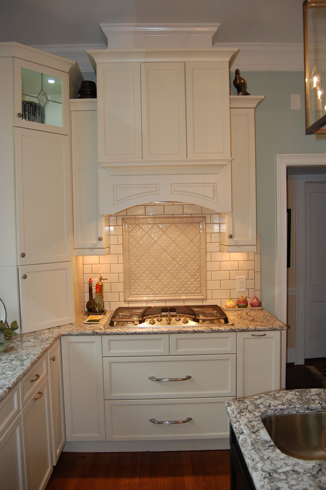 Transitional u-shaped eat-in kitchen photo in Raleigh with an undermount sink, recessed-panel cabinets, white cabinets, quartzite countertops, white backsplash, subway tile backsplash and stainless steel appliances