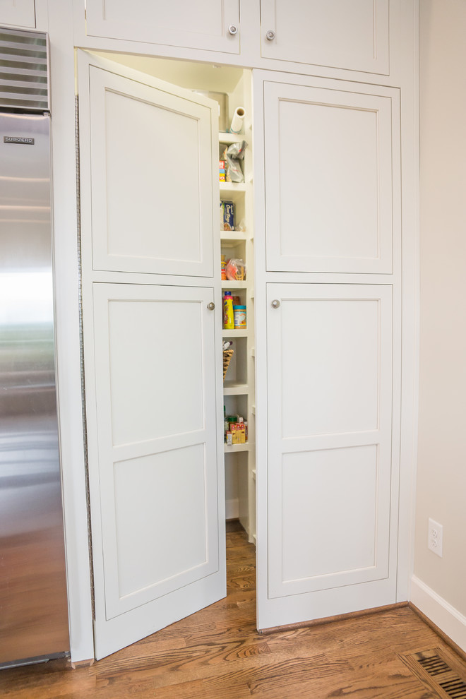 Inspiration for a huge transitional l-shaped medium tone wood floor eat-in kitchen remodel in Birmingham with an undermount sink, recessed-panel cabinets, white cabinets, granite countertops, multicolored backsplash, glass tile backsplash, stainless steel appliances and an island