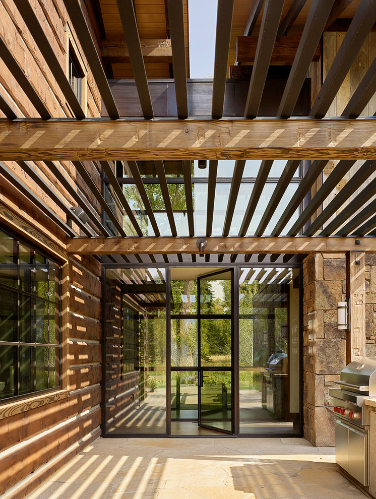 Example of a mountain style entryway design with a glass front door