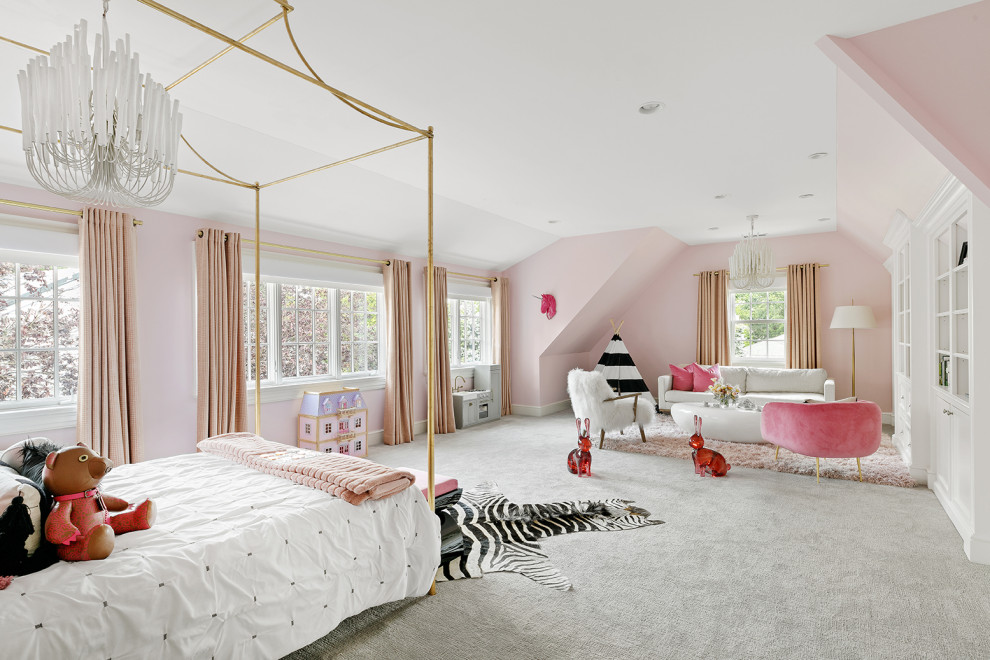 This is an example of a large transitional kids' bedroom for girls in New York with pink walls, carpet and grey floor.