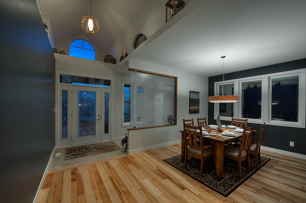 Inspiration for a mid-sized transitional medium tone wood floor hallway remodel with blue walls