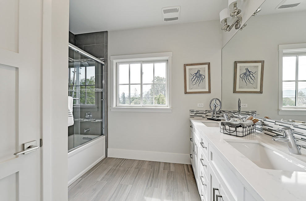 Transitional 3/4 bathroom in San Francisco with shaker cabinets, white cabinets, an alcove tub, a shower/bathtub combo, grey walls, light hardwood floors, an undermount sink and marble benchtops.