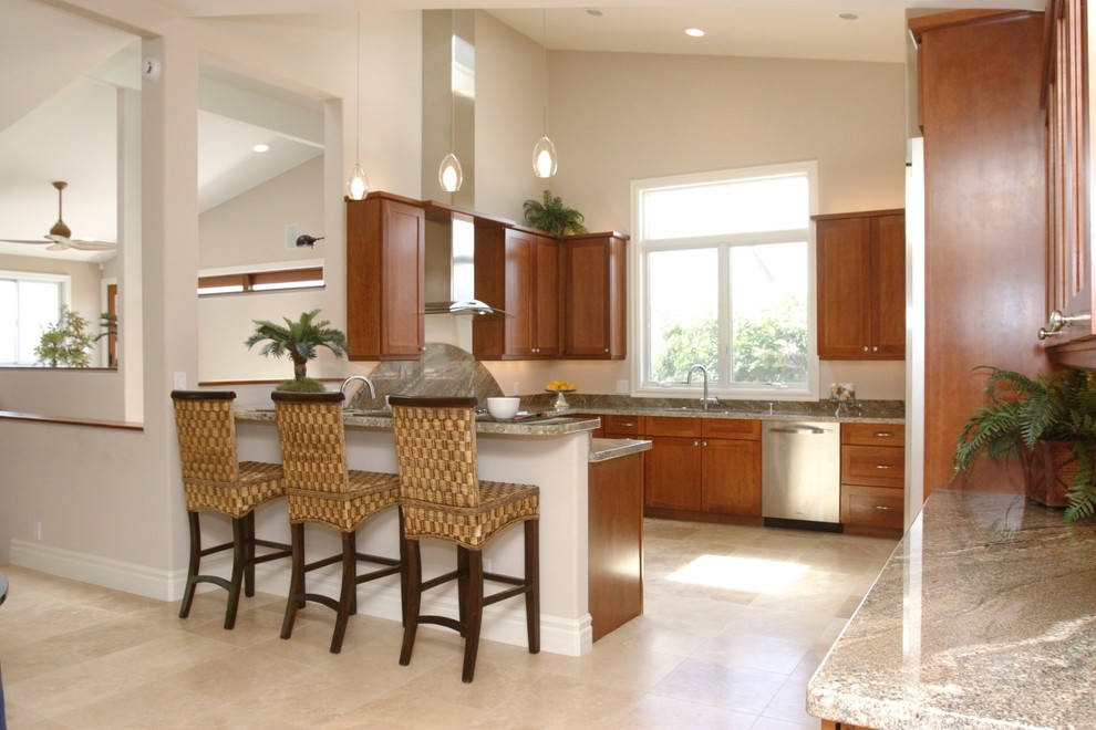 Photo of a mid-sized tropical u-shaped kitchen in Hawaii with an undermount sink, shaker cabinets, medium wood cabinets, granite benchtops, green splashback, stone slab splashback, stainless steel appliances and a peninsula.