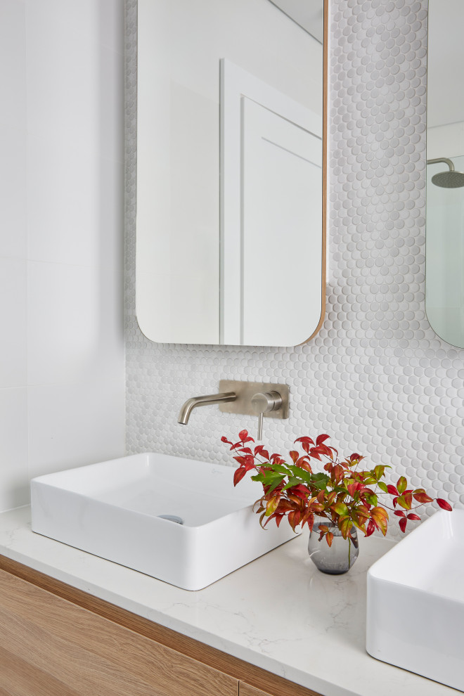 This is an example of a scandinavian bathroom in Sydney with light wood cabinets, a one-piece toilet, white tile, ceramic tile, ceramic floors, marble benchtops, grey floor, white benchtops, a double vanity and a floating vanity.