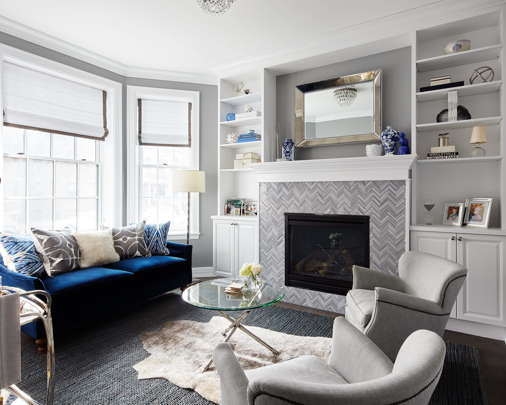 This is an example of a mid-sized transitional open concept living room in Chicago with grey walls, a standard fireplace, a tile fireplace surround, dark hardwood floors, no tv and brown floor.