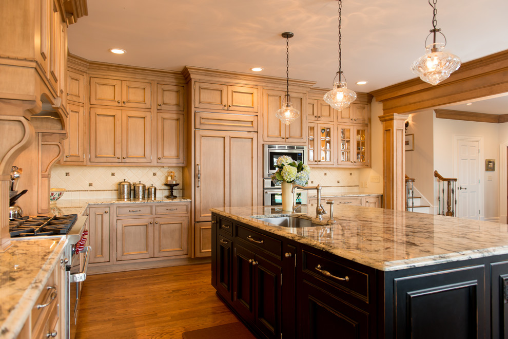 Design ideas for a traditional kitchen in Cleveland with recessed-panel cabinets, panelled appliances and light wood cabinets.