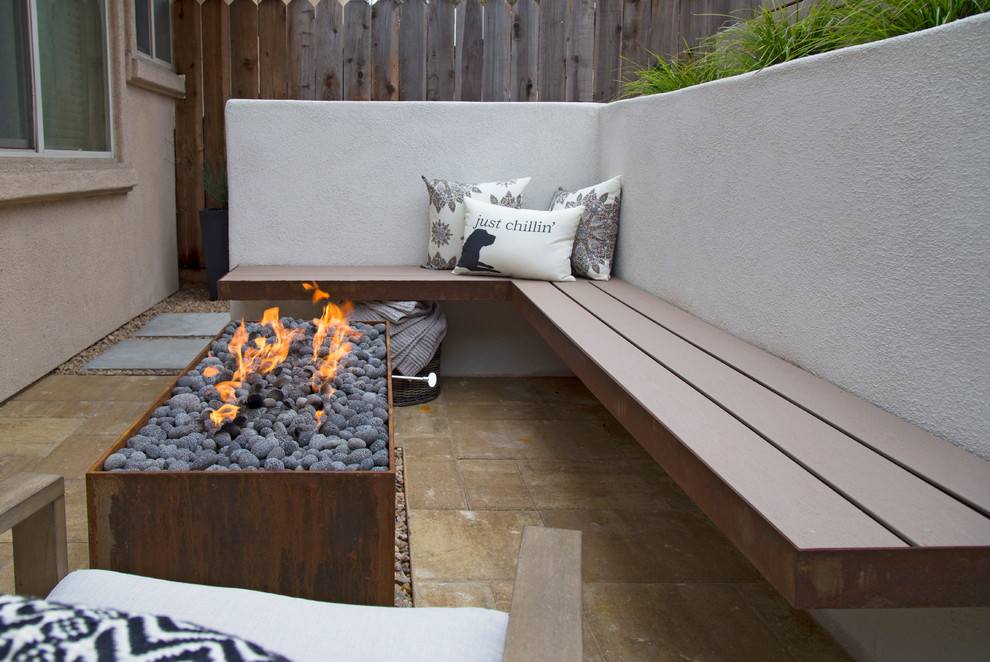 Photo of a small modern backyard patio in San Luis Obispo with a fire feature and concrete pavers.