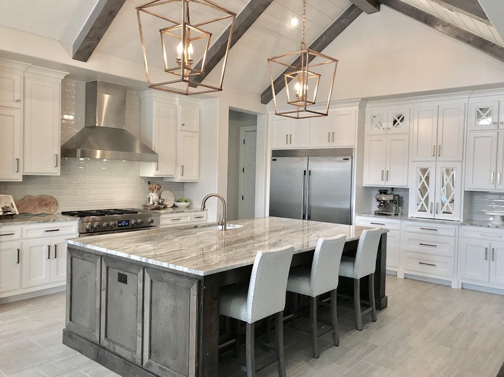 Large transitional ceramic tile and multicolored floor kitchen photo with a double-bowl sink, shaker cabinets, white cabinets, granite countertops, gray backsplash, ceramic backsplash, stainless steel appliances and an island