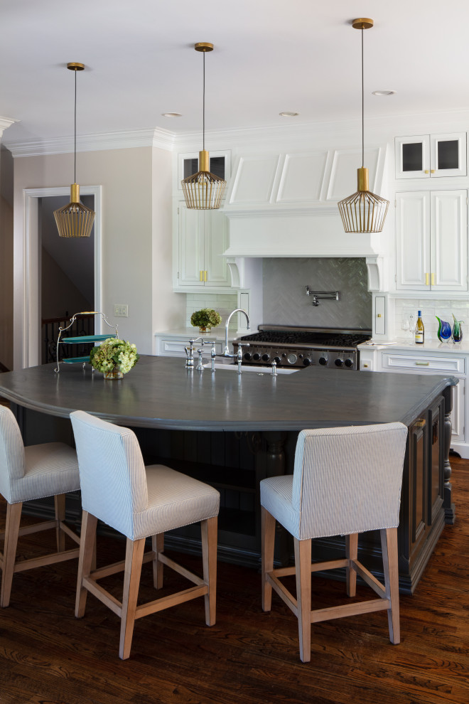 Inspiration for a large transitional u-shaped dark wood floor and brown floor eat-in kitchen remodel in Atlanta with a farmhouse sink, recessed-panel cabinets, white cabinets, quartz countertops, white backsplash, ceramic backsplash, stainless steel appliances, an island and white countertops
