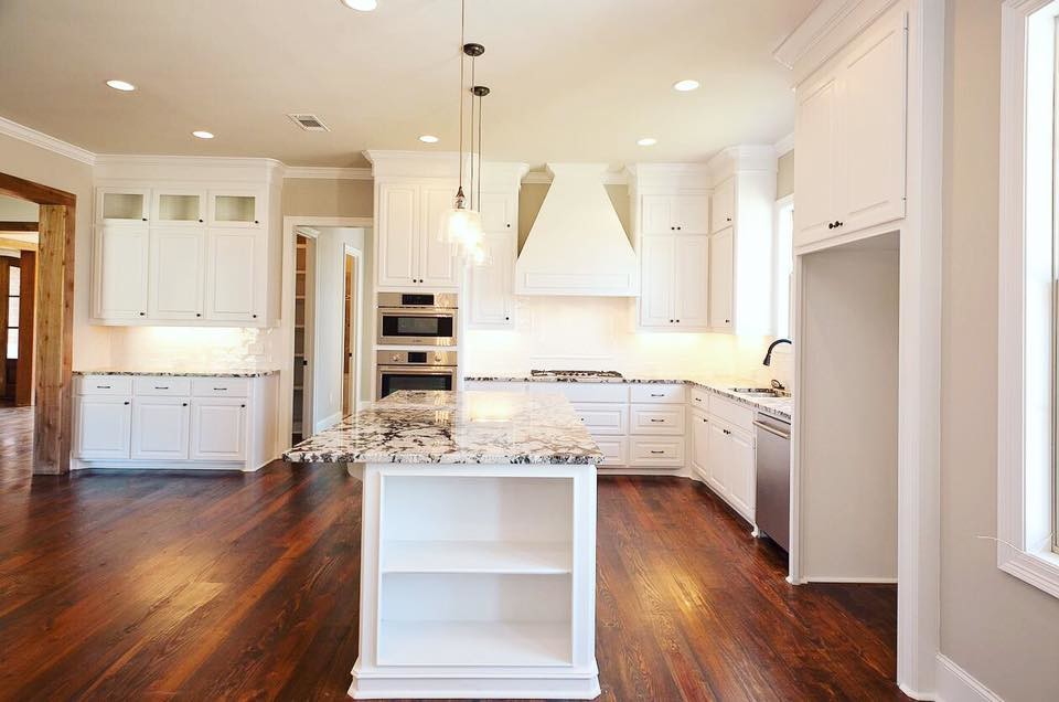Open concept kitchen - mid-sized transitional l-shaped dark wood floor and brown floor open concept kitchen idea in Jackson with a double-bowl sink, raised-panel cabinets, white cabinets, granite countertops, white backsplash, ceramic backsplash, stainless steel appliances and an island