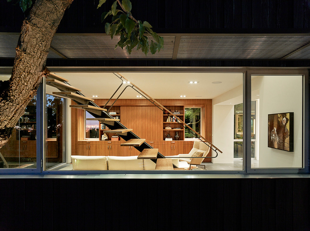 Photo of a large modern two-storey black exterior in San Francisco with wood siding.