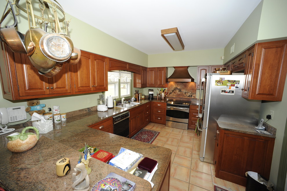 Example of a mid-sized transitional u-shaped limestone floor enclosed kitchen design in Baltimore with an undermount sink, beaded inset cabinets, dark wood cabinets, granite countertops, beige backsplash, stone tile backsplash, stainless steel appliances and a peninsula