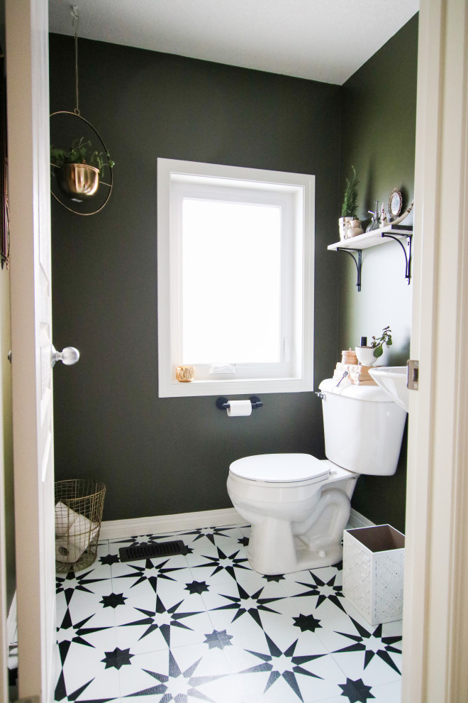 Photo of a small eclectic powder room in Calgary with green walls.