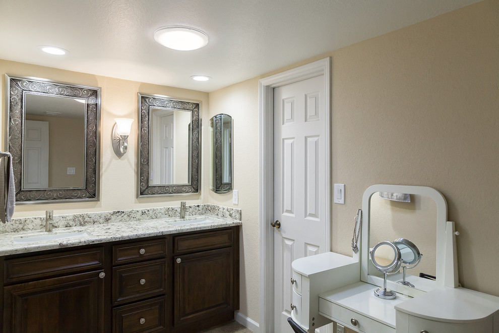 Mid-sized transitional master gray tile and porcelain tile porcelain tile and brown floor walk-in shower photo in Phoenix with shaker cabinets, dark wood cabinets, a one-piece toilet, beige walls, an undermount sink, granite countertops and beige countertops