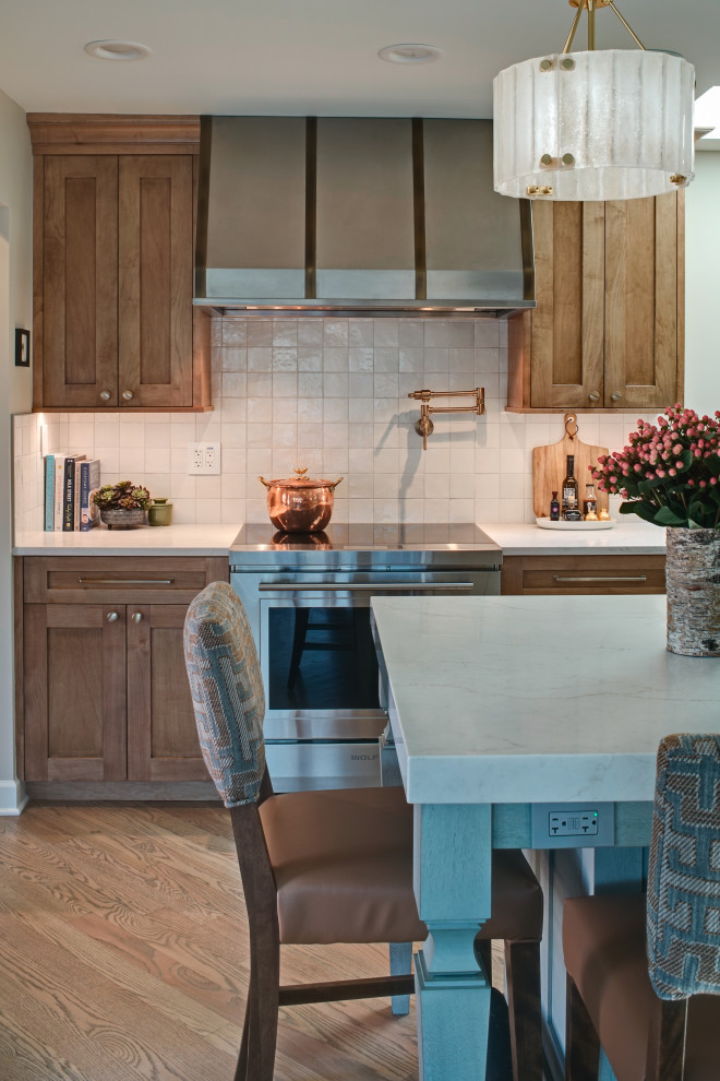 Inspiration for a mid-sized transitional l-shaped medium tone wood floor and brown floor open concept kitchen remodel in Chicago with an undermount sink, shaker cabinets, medium tone wood cabinets, quartz countertops, white backsplash, ceramic backsplash, stainless steel appliances, an island and white countertops