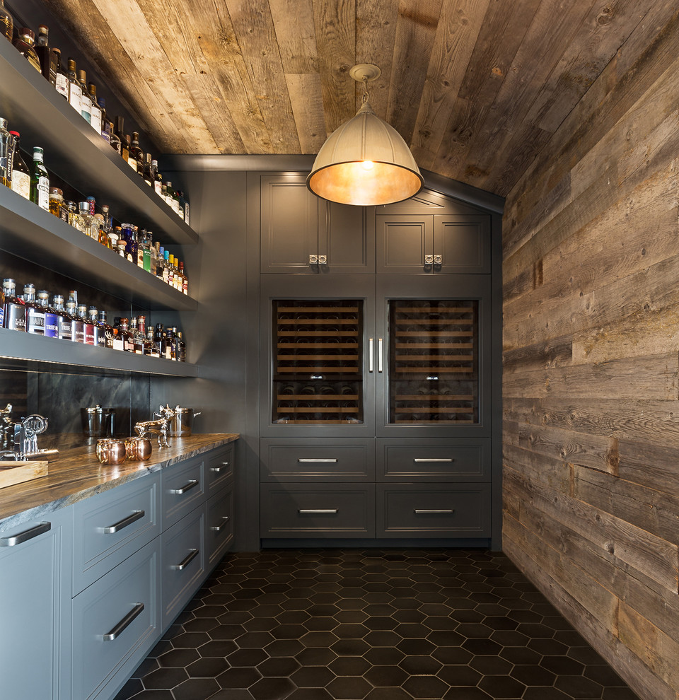 Inspiration for a mid-sized transitional single-wall home bar in Austin with grey cabinets, black floor, shaker cabinets, granite benchtops, multi-coloured splashback and mirror splashback.