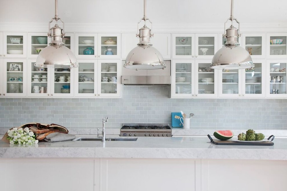 Inspiration for a mid-sized transitional galley eat-in kitchen in Sydney with an undermount sink, glass-front cabinets, white cabinets, marble benchtops, grey splashback, glass tile splashback, stainless steel appliances, medium hardwood floors and with island.