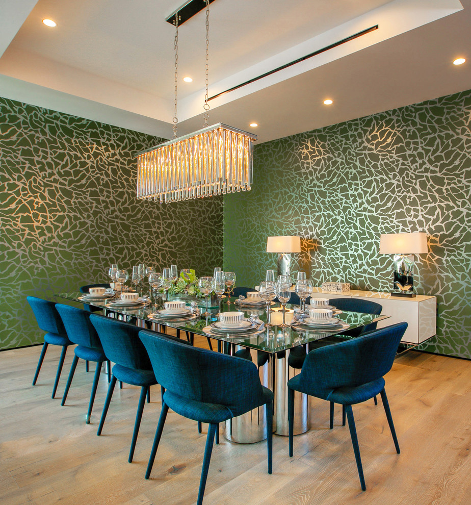 Contemporary dining room in Los Angeles with green walls, light hardwood floors and brown floor.