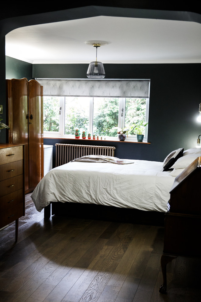 This is an example of a large contemporary master bedroom in Other with green walls, vinyl floors and brown floor.