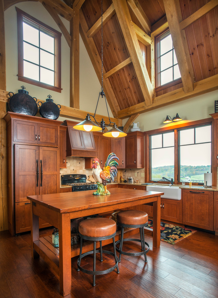Inspiration for a country l-shaped kitchen in Columbus with a farmhouse sink, shaker cabinets, dark wood cabinets, beige splashback, panelled appliances, dark hardwood floors and with island.