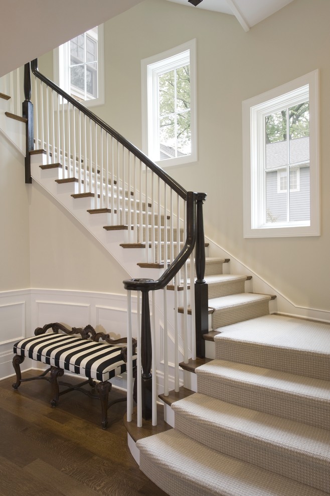 This is an example of a mid-sized arts and crafts wood l-shaped staircase in Chicago with painted wood risers.