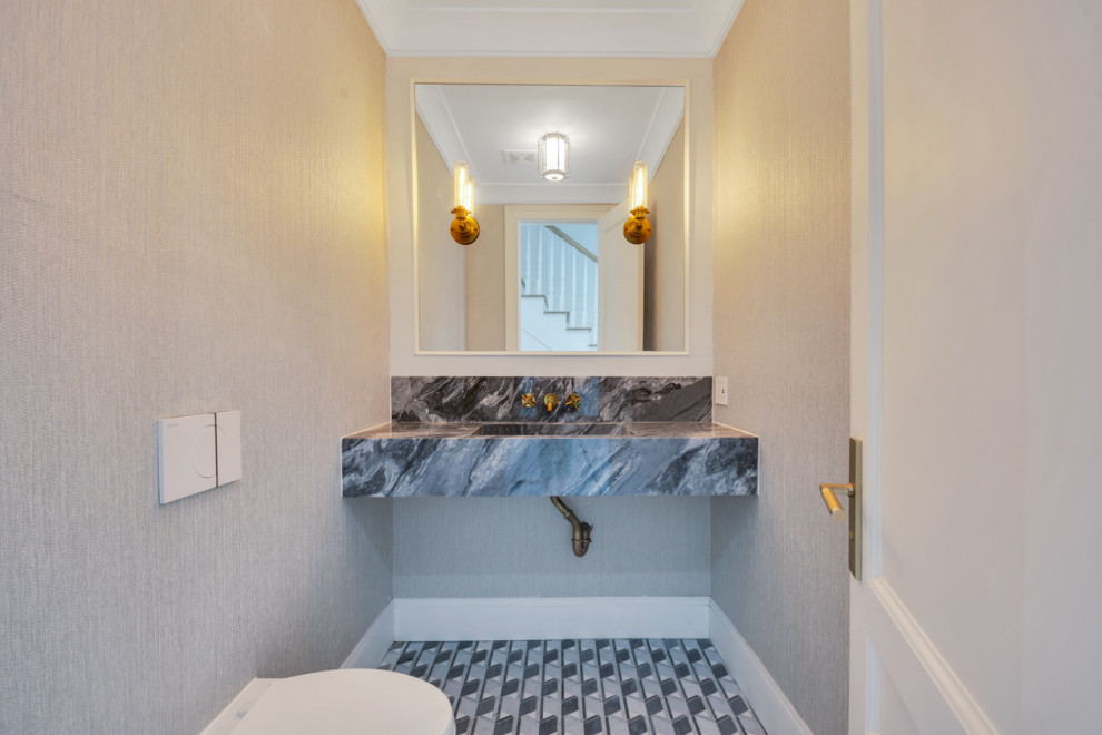 This is an example of a medium sized midcentury cloakroom in New York with a wall mounted toilet, marble worktops, multi-coloured worktops, a floating vanity unit and wallpapered walls.