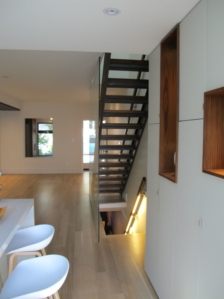 Mid-sized contemporary metal straight staircase in Toronto with wood risers.